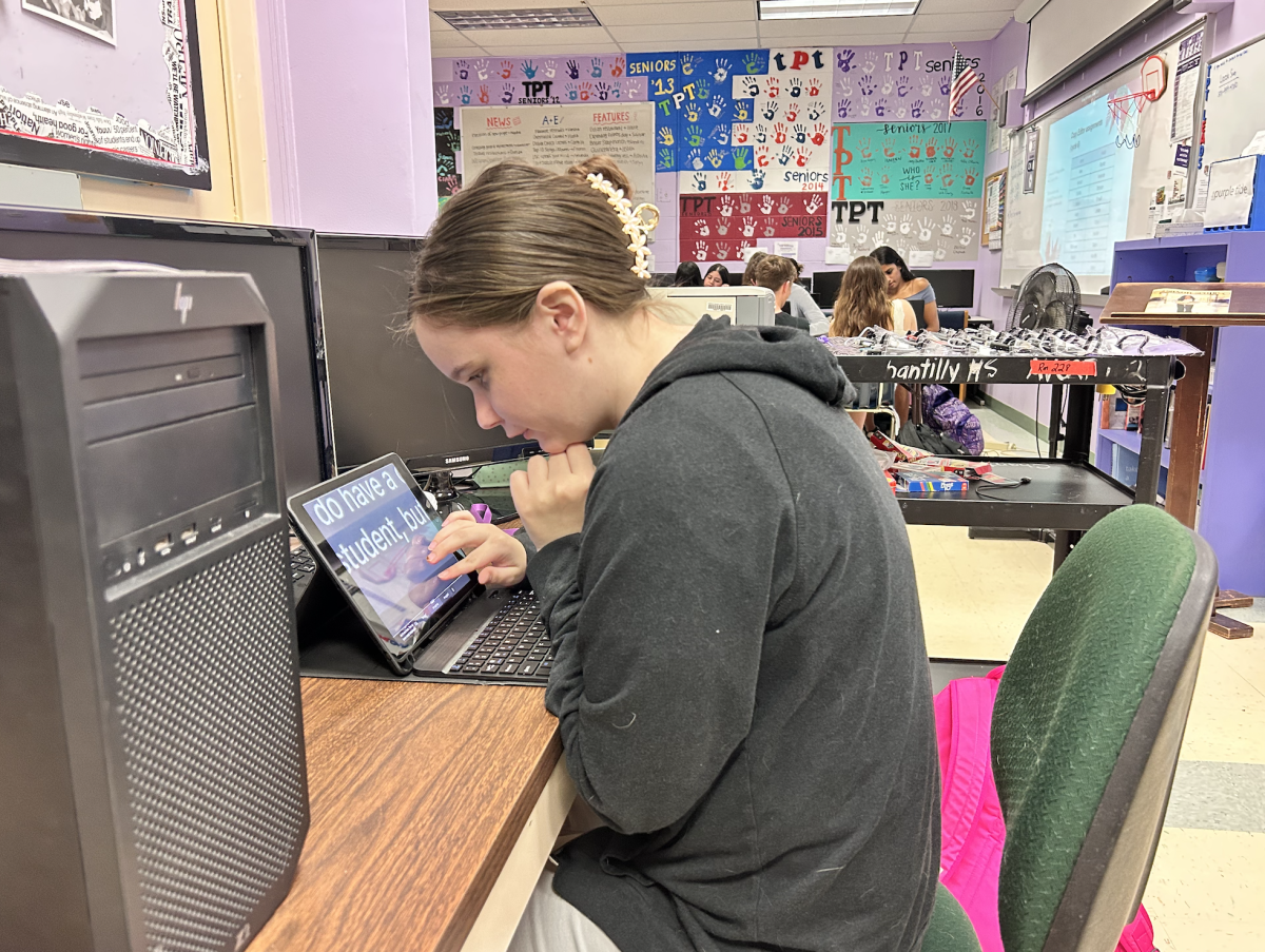 Senior Delaney Brooks scans an article for grammatical errors on May 2. She checked for AP Style rules, including one that does not allow Oxford commas in the context of lists. 